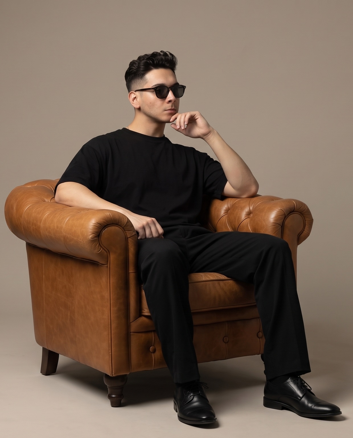 Alex Murillo seated in a tan leather chair
